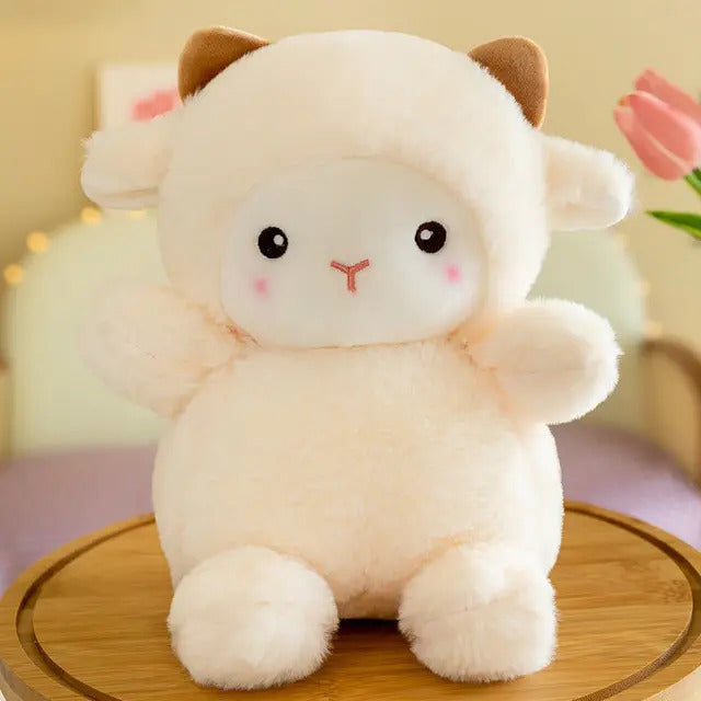 A soft plush toy sheep, with pink cheeks and soft white in color, with brown horns.