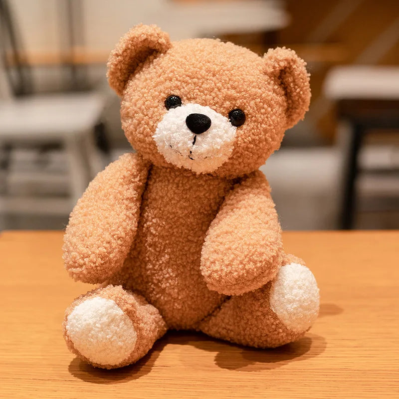 brown bear plush toy sits on a table at a café setting