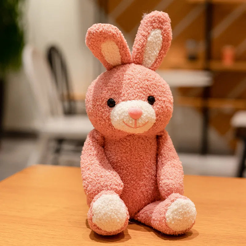 pink rabbit plush toy sits on a table in a café setting