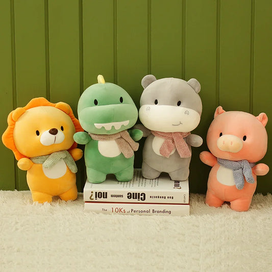 A collection of four soft plush toy animals, including a lion, a crocodile, a hippo, and a pig, standing side by side with a green background.